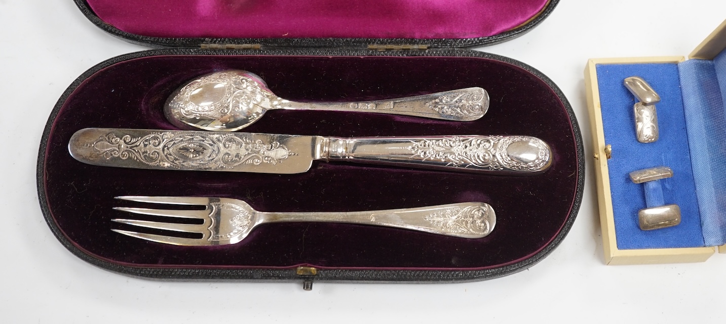 A late Victorian cased chased silver christening trio, London, 1897/90, together with a pair of engraved 925 cufflinks. Condition - fair